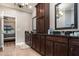 Bathroom featuring a long vanity with double sinks, dark wood cabinets, and a large mirror at 6346 Dallas Blvd, Orlando, FL 32833