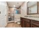 Bathroom featuring a glass-enclosed shower and granite-topped vanity with dark wood cabinets at 6346 Dallas Blvd, Orlando, FL 32833