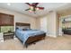 Comfortable bedroom with modern furniture, a ceiling fan, and natural light at 6346 Dallas Blvd, Orlando, FL 32833