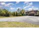 Expansive home exterior with a long driveway, lush greenery, and inviting outdoor seating at 6346 Dallas Blvd, Orlando, FL 32833