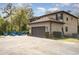 Exterior side view highlighting the home's two-car garage and inviting outdoor seating area at 6346 Dallas Blvd, Orlando, FL 32833