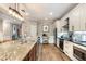 Well-lit kitchen featuring granite countertops, modern appliances, and a breakfast bar area at 6346 Dallas Blvd, Orlando, FL 32833