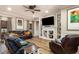 Cozy living room with built-in shelving, a ceiling fan, and comfortable leather furniture at 6346 Dallas Blvd, Orlando, FL 32833