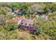 An aerial view of a stately brick home with lush surrounding landscape at 721 Delaney Ave, Orlando, FL 32801