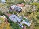 Aerial view of estate featuring a large red brick home, pool and lush tree coverage at 721 Delaney Ave, Orlando, FL 32801