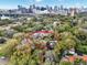 Aerial view of a residential property with a pool, brick drive, green lawn and skyline view at 721 Delaney Ave, Orlando, FL 32801