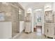 Elegant bathroom featuring a glass shower and dual vanities with ornate detailing at 721 Delaney Ave, Orlando, FL 32801