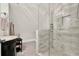 Elegant bathroom featuring glass enclosed shower, marble tile, and a black vanity at 721 Delaney Ave, Orlando, FL 32801