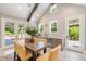 Light-filled dining area with a wooden table, seating six, and outdoor access at 721 Delaney Ave, Orlando, FL 32801