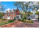 Stately red brick home with beautiful landscaping and a detached garage at 721 Delaney Ave, Orlando, FL 32801