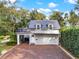 Charming two-story home with a brick driveway and a balcony above the garage at 721 Delaney Ave, Orlando, FL 32801