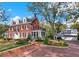 Charming brick two-story home with lush landscaping, screened porch and a detached garage with extra living space at 721 Delaney Ave, Orlando, FL 32801