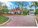 Beautiful brick home with long brick driveway, manicured landscaping and separate garage at 721 Delaney Ave, Orlando, FL 32801