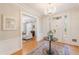 Elegant foyer featuring a crystal chandelier, hardwood floors, and sophisticated decor at 721 Delaney Ave, Orlando, FL 32801