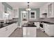 Charming kitchen featuring white cabinetry, dark countertops, an island and stainless steel appliances at 721 Delaney Ave, Orlando, FL 32801