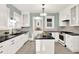 Bright kitchen with white cabinetry, an island, and stainless steel appliances at 721 Delaney Ave, Orlando, FL 32801