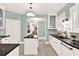 Charming kitchen featuring a center island, black countertops, and mosaic tile flooring at 721 Delaney Ave, Orlando, FL 32801