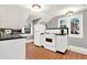 Cozy kitchen with white cabinets, black countertops, and terracotta tile flooring at 721 Delaney Ave, Orlando, FL 32801