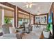 Comfortable living room with exposed brick walls, plantation blinds, a ceiling fan, and a cozy sitting area at 721 Delaney Ave, Orlando, FL 32801