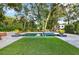 Relaxing backyard pool and hot tub area surrounded by a stone patio and artificial turf at 721 Delaney Ave, Orlando, FL 32801