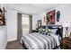 Stylized bedroom with striped bedding, dark trim, skateboard wall décor and a work desk at 7821 Waterscape Dr, Groveland, FL 34736