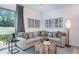 Comfortable living room featuring a beige sofa, stylish pillows, unique coffee table and modern decor at 7821 Waterscape Dr, Groveland, FL 34736