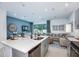 Open-concept living space featuring a modern kitchen island, dining area, and comfortable seating arrangement at 7821 Waterscape Dr, Groveland, FL 34736