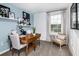 Bright office with a wood desk, an accent chair, and light blue accent wall with modern décor at 7821 Waterscape Dr, Groveland, FL 34736