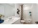 Well-lit bathroom with a sink, toilet, shower-tub combination, and stylish decor at 7823 Waterscape Dr, Groveland, FL 34736