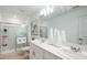 Bright bathroom with a glass-enclosed shower, double sinks, and modern fixtures at 7823 Waterscape Dr, Groveland, FL 34736