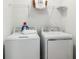 Laundry room with white, front-load washing machine and dryer and wire shelving at 7823 Waterscape Dr, Groveland, FL 34736