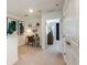 Upstairs hallway with artwork, a desk, and a view into another bedroom at 7823 Waterscape Dr, Groveland, FL 34736