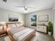 Bright bedroom featuring a ceiling fan, contemporary decor, and a large window offering natural light at 832 Yellowbird Ave, Deltona, FL 32725