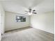 Bedroom with a ceiling fan, window, and neutral carpet at 832 Yellowbird Ave, Deltona, FL 32725