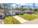 Aerial view of a single Gathering home with a long driveway and lush green lawn at 970 Picasso Ave, Deltona, FL 32738