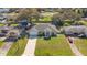 Aerial view of a single Gathering home with a long driveway, lush green lawn, and manicured landscape at 970 Picasso Ave, Deltona, FL 32738