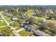 Aerial view of a home with a large front lawn and mature trees in a quiet neighborhood at 970 Picasso Ave, Deltona, FL 32738