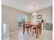 Dining area features tile floors, a chandelier, a beverage cooler and a window with blinds at 970 Picasso Ave, Deltona, FL 32738