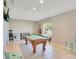 Spacious game room with a pool table, window and tile floors, perfect for entertainment at 970 Picasso Ave, Deltona, FL 32738