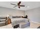 Cozy main bedroom features a ceiling fan, accent chair, and tiled floors at 970 Picasso Ave, Deltona, FL 32738