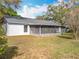 Home's exterior view shows a backyard with screened patio at 10238 Summit Square Dr, Leesburg, FL 34788