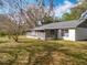 Exterior backyard view with a screened-in porch and lawn space shaded by mature trees at 10238 Summit Square Dr, Leesburg, FL 34788