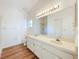 Bright bathroom with dual sinks, vanity, large mirror, and updated fixtures at 10238 Summit Square Dr, Leesburg, FL 34788