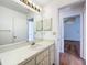 Bathroom featuring a sink, mirror, and cabinetry at 10238 Summit Square Dr, Leesburg, FL 34788