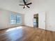 Bedroom with new flooring, neutral walls, fan, and natural light from a window at 10238 Summit Square Dr, Leesburg, FL 34788