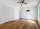 Bedroom with wood-look flooring, closet, and a window at 10238 Summit Square Dr, Leesburg, FL 34788