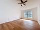 Bedroom with wood-look floors and ceiling fan at 10238 Summit Square Dr, Leesburg, FL 34788