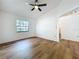 Bedroom featuring neutral walls, ceiling fan, new flooring, and ample natural light at 10238 Summit Square Dr, Leesburg, FL 34788