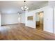 Spacious living room featuring an open layout, vaulted ceiling, fan, and wood-look flooring at 10238 Summit Square Dr, Leesburg, FL 34788