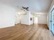 Bright living room with vaulted ceilings, wood-look floors, and sliding glass doors to the screened patio at 10238 Summit Square Dr, Leesburg, FL 34788